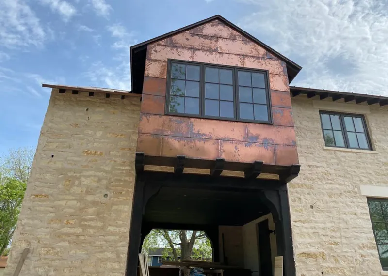 Copper metal panel facade on a stone building for Skylight Installation in Cullman