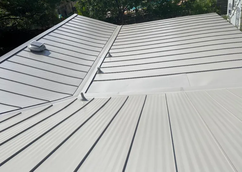 Solar attic fan installed on a metal roof for Roof Ventilation in Cullman